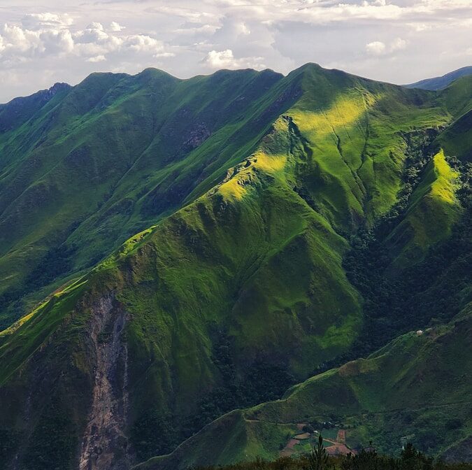 green mountain under white clouds during daytime